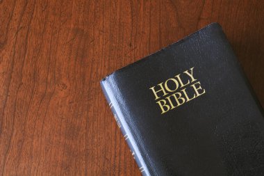 Holy Bible on wood surface clipart