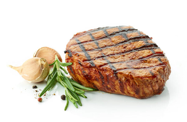 Grilled beef fillet steak, rosemary and garlic isolated on white background