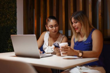 Girişimci Kadınlar telefona bakan Fikirleri tartışıyorlar. Yüksek kalite fotoğraf