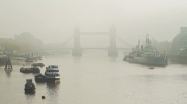 Tower Bridge in London in foggy misty weather, with mist and fog on the River Thames in beautiful mysterious atmospheric light, shot in the Coronavirus Covid-19 pandemic lockdown in England, Europe
