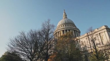 Popular London tourist attraction and landmark of St Pauls Cathedral on a bright blue sky day with Autumn trees, shot in the Coronavirus Covid-19 Lockdown when it was quiet in England, Europe