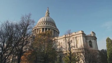 Popular London tourist attraction and landmark of St Pauls Cathedral on a bright blue sky day with Autumn trees, shot in the Coronavirus Covid-19 Lockdown when it was empty in England, Europe
