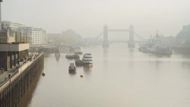 Tower Bridge skyline in London in foggy misty weather, with mist and fog on the River Thames in beautiful golden sunlight, shot in the Coronavirus Covid-19 pandemic lockdown in England