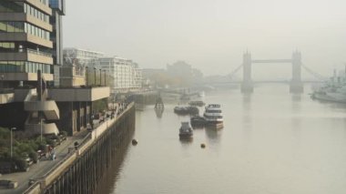 Tower Bridge skyline in London in foggy misty weather, with mist and fog on the River Thames in beautiful golden sunlight, shot in the Coronavirus Covid-19 pandemic lockdown in England