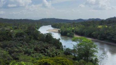 Aerial Drone View of Rainforest River and Mountains Scenery in Costa Rica at Boca Tapada, San Carlos River (Rio San Carlos) that Connects to Nicaragua in Central America, High Shot Above Trees