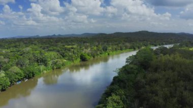 Aerial Drone View of Rainforest River and Mountains Scenery in Costa Rica at Boca Tapada, San Carlos River (Rio San Carlos) that Connects to Nicaragua in Central America, High Shot Above Trees
