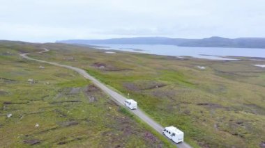Aerial Drone View of Scotland Highlands Road Trip Driving Holiday in Mountains, with Car on Scottish Roads of NC500 (North Coast 500 Route) on an Adventure in Beautiful Scottish Landscape