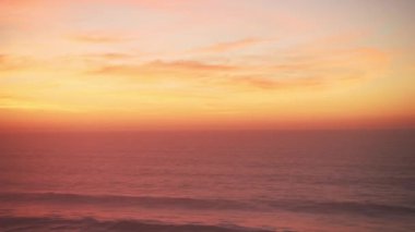Dramatic Sunset Clouds over Horizon and Waves Breaking in Ocean Background with Copy Space, Orange Seascape Coastal Scene from Aerial Drone View