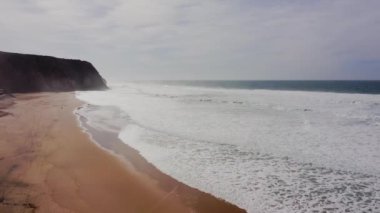 Praia Grande Beach at Sintra, Lisbon, Portugal, on the Atlantic Coast, a Beautiful Sandy Beach with Cliffs in Europe