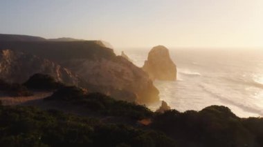 Aerial Drone Shot of Lisbon Portugal Dramatic Coast, Beautiful Coastal Landscape in Orange Sunset Light With Atlantic Ocean, Cliffs and Amazing Rock Formations Rugged Seascape, Europe