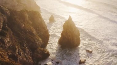 Aerial Drone View of Dramatic Coastal Landscape and Scenery of Cliffs, Rock Formations and Rocks on the Atlantic Coast of Portugal, Europe With Orange Sunset Light