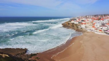 Aerial Drone View of Sandy Beach at Lisbon, Portugal at Praia das Macas, a Beautiful Coastal Town, Popular Tourist Destination with Clear Blue Sky on Sunny Day, Atlantic Ocean Coast, Europe