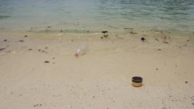 Single Use Plastic Bottle Floating on Ocean Sea Water at Beach, Rubbish Garbage Trash and Waste Causing Human Impact on Marine Conservation and Dirty Water Pollution Issue