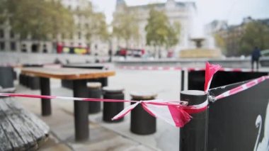 Covid-19 Coronavirus pandemic lockdown with table and chairs close and shut with tape to cordon it off in Central London for safety and social distancing in England, UK