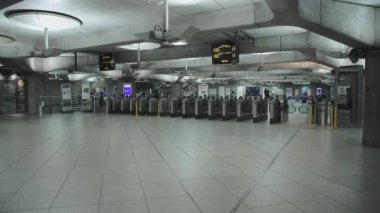 Covid-19 Coronavirus lockdown pandemic in London Underground tube train in England, UK showing one person at Westminster station, empty, quiet and deserted