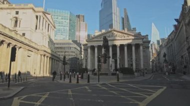 Bank of England with empty roads and quiet streets with almost no people and traffic during the Coronavirus pandemic Covid-19 lockdown, taken at rush hour in the City of London, England, Europe