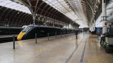 One person walking wearing face mask covering in Paddington Train Station during Coronavirus Covid-19 lockdown in London when public transport was quiet and deserted with no people in England, Europe