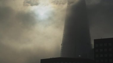London timelapse of The Shard, a time lapse of dramatic moody clouds and mist moving, and the sun rising on a misty foggy morning in London, shot in Covid-19 Coronavirus lockdown in England, Europe