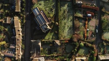 Aerial drone video of a Cotswolds Village, a rural scene in English countryside with houses, property and real estate in the UK housing market, top down vertical shot of Bourton on the Hill, Gloucestershire, England