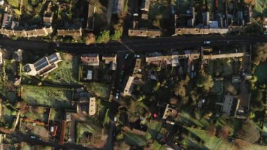 Aerial drone video of a Cotswolds Village, a rural scene in English countryside with houses, property and real estate in the UK housing market, top down vertical shot of Bourton on the Hill, Gloucestershire, England