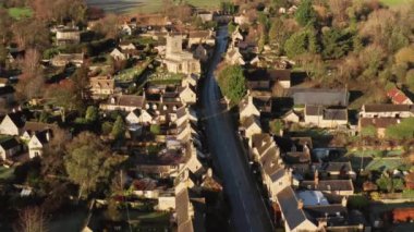 Aerial drone video of a Cotswolds Village, a rural scene in English countryside with houses, property and real estate in the UK housing market, Bourton on the Hill, Gloucestershire, England