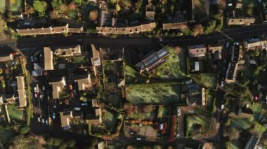 Aerial drone video of a Cotswolds Village, a rural scene in English countryside with houses, property and real estate in the UK housing market, top down vertical shot of Bourton on the Hill, Gloucestershire, England