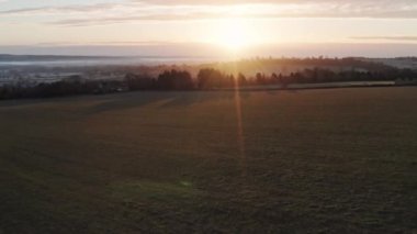 Aerial drone video of Rural English countryside and fields on a farm in beautiful British scenery in The Cotswolds at sunrise in beautiful morning light at Longborough, Gloucestershire, England, UK