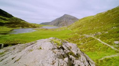 Stunning natural mountain landscape scenery of Cwm Idwal Lake in Glyderau range of Snowdonia National Park, pan right