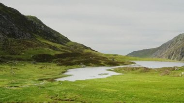 Stunning natural mountain landscape scenery of Cwm Idwal Lake in Glyderau range of Snowdonia, pan right