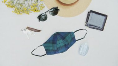 Top down view of manly personal items, coronavirus era essentials flat lay, concept of items a person will carry around. mandatory face mask for safety, pan right