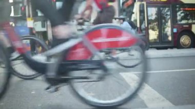 Bikers Cycling On The Bike Lane In London, UK. Road Traffic In The Background - ground-level shot