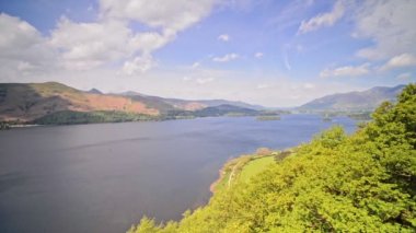 Beautiful Landscape At The Lake District Surrounded By The Green Mountains Under the Blue Sky During Summer In England.- wide shot