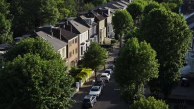 Rows Of Houses With Cars Parked In Front At Residential Terraced Houses In Central North London, UK - high angle drone shot