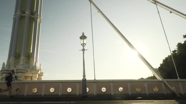 Male Running Outdoors London Street Bridge Morning Sun Flare Lockdown — Vídeo de stock