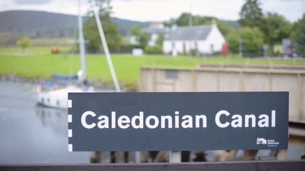 Caledonian Canal Sign Scotland Sailboats Passing Background — Stockvideo