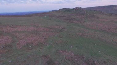 Granite rock formation in Dartmoor National Park at sunset, Devon, England, UK. Aerial drone view