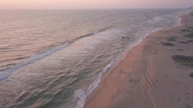 The Stunning Scenery Of The Waves Crashing On The Shore In Varkala, India During Golden Hours - Aerial Shot