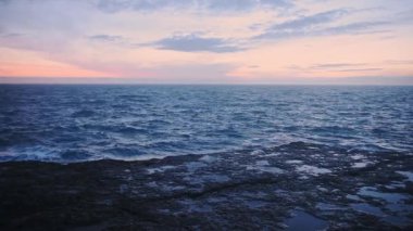 Man Taking Photos On The Beautiful Calm Sea in Dorset, England During Golden Hours - Wide Shot
