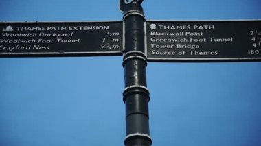 A Metal Sign Post Conveying The Directions Of Thames Path Extension And Thames Path Located In Southeast London. -medium shot