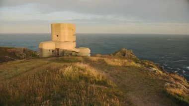 Landscape view of Fort Grey, Guernsey, with the sea in the background, at dusk