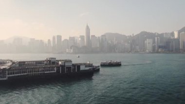 Boat Arriving And Leaving Port Area To Transport Passengers In Hong Kong - wide shot