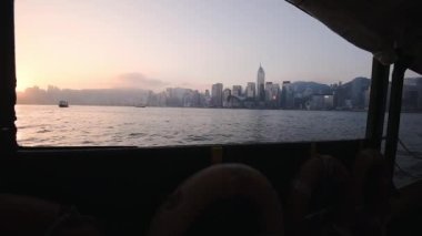 Glorious Sunset Scenery By The Victoria Harbour While Cruising In A Ferry Boat With Hong Kong Skyline View - Wide Shot