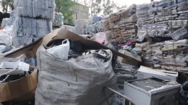 Big Sacks And Plastics Of Waste Put Together In A Shelter With Roof In Hongkong. -wide shot