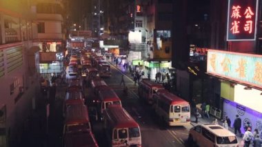 View Of Busy Street In Hong Kong With People Walking In The Street and Different Cars Passing By The Road During Nighttime - Aerial Shot