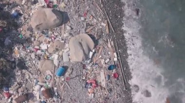 Climate change is impacted by beach covered in plastic and rubbish in Hong Kong. Aerial drone view