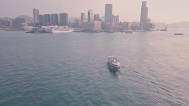 Star ferry from Hong Kong Island to Kowloon at sunrise. Aerial drone view