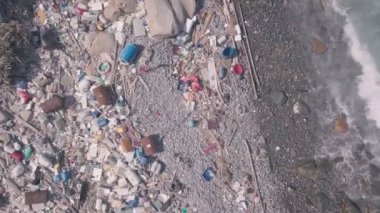 Environmental issues shown by beach covered in plastic and rubbish in Hong Kong. Static aerial drone view