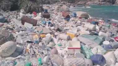 Environmental destruction caused by beach covered in plastic and rubbish causing climate change in Hong Kong. Aerial drone view
