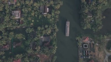 Boat trip around Kerala backwaters at Alleppey, India. Aerial top down drone view
