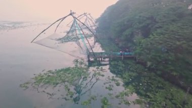 Traditional Chinese fishing nets at sunrise, Fort Kochi, India. Aerial drone view